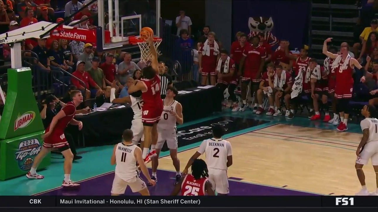 Carter Gilmore flushes a put-back dunk to extend Wisconsin's lead over Virginia