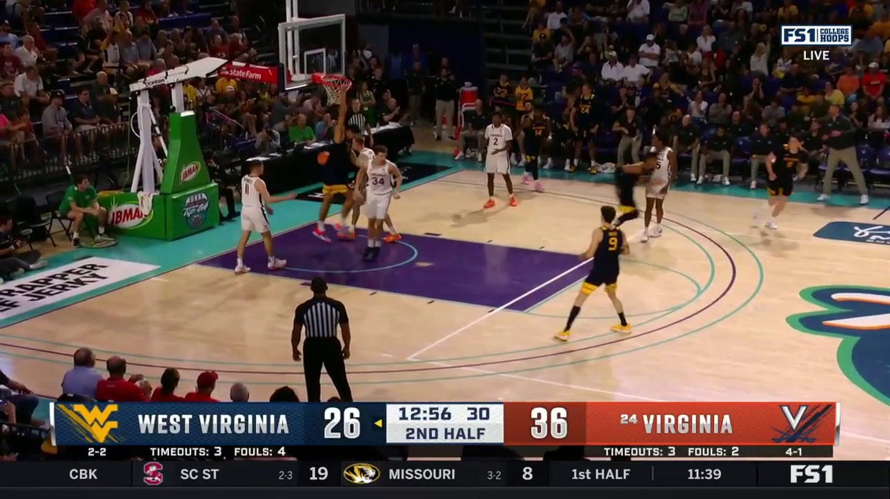 West Virginia's Jesse Edwards throws down a two-handed jam to cut Virginia's lead