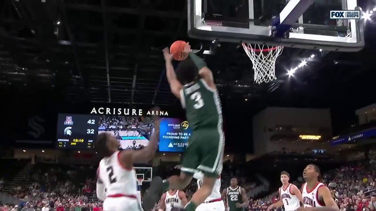 Michigan State's Jaden Akins slams a two-handed alley-oop from Tyson Walker to shrink Arizona's lead
