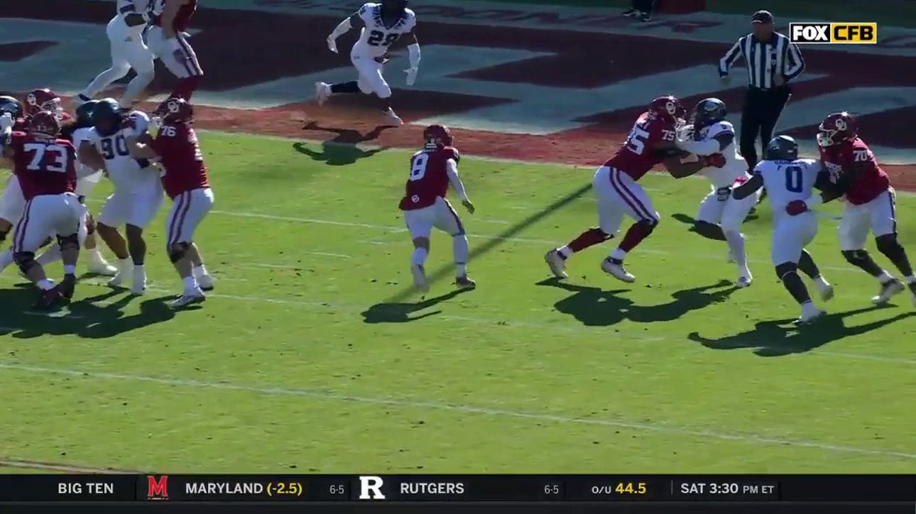 Dillon Gabriel storms past TCU's defense on a 8-yard rushing TD to give Oklahoma a 7-0 lead