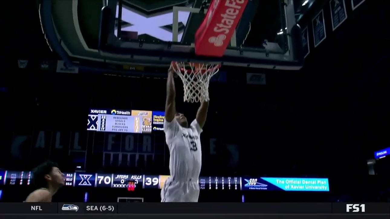 Dailyn Swain steals a pass, then elevates for a strong two-handed slam to strengthen Xavier's lead over Bryant