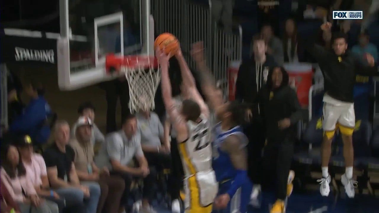 Patrick McCaffery takes off for a strong two-handed slam to give Iowa a 73-65 lead over Seton Hall 