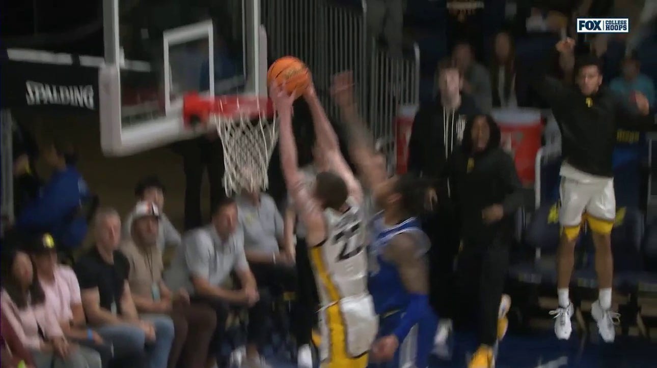 Patrick McCaffery takes off for a strong two-handed slam to give Iowa a 73-65 lead over Seton Hall 