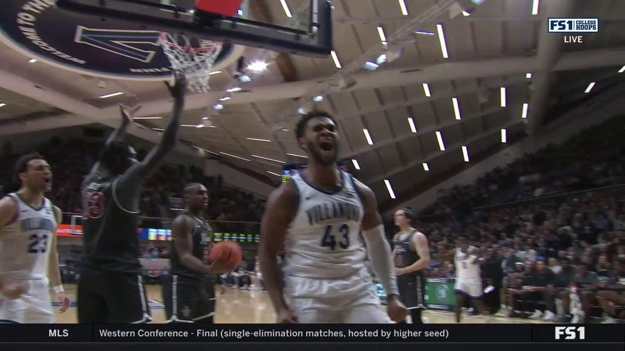 Villanova's Eric Dixon muscles his way inside for the tough bucket plus the foul vs. Saint Joseph's