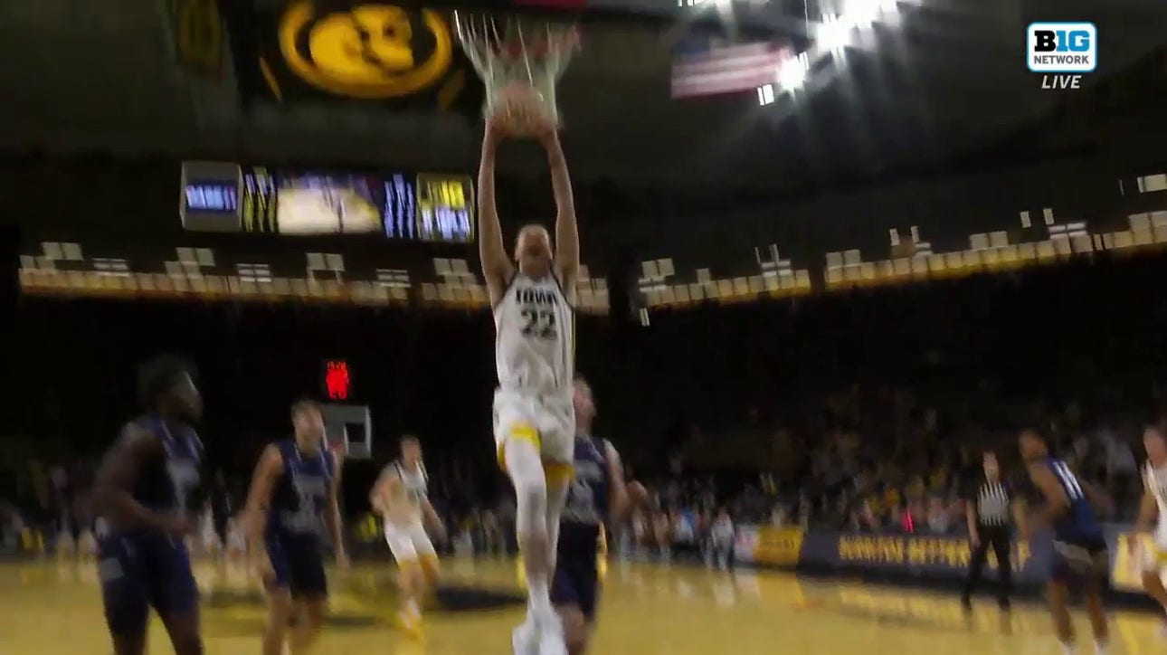 Patrick McCaffery drives through the lane and finishes a two-handed slam to give Iowa a 49-45 lead over North Florida
