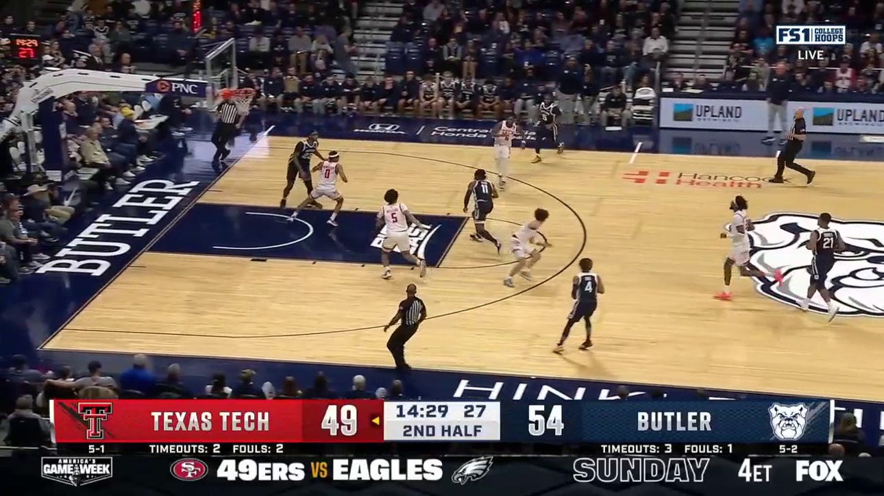 Jahmyl Telfort loses the defender with a behind-the-back move and finishes at the rim, extending Butler's lead over Texas Tech