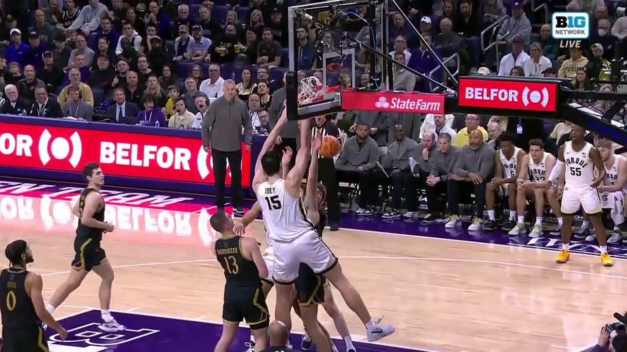 Zach Edey muscles his way inside for a two-handed flush, extending Purdue's lead over Northwestern