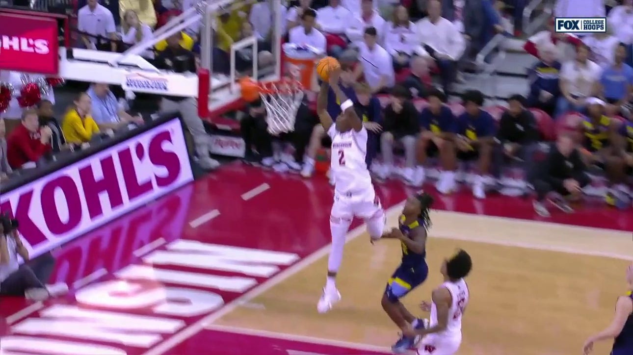 AJ Storr rises for the two-handed alley-oop in transition, extending Wisconsin's lead over Marquette