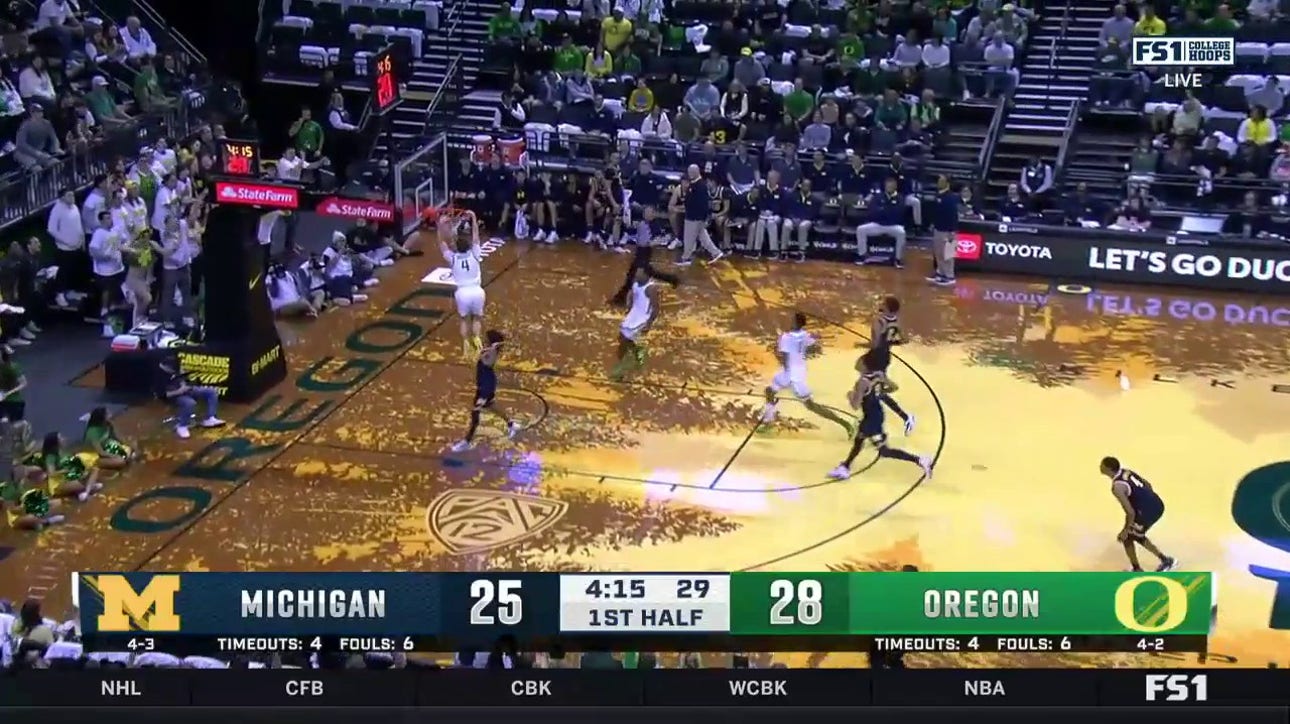 Brennan Rigsby throws down a two-handed jam on the fast break to extend Oregon's lead over Michigan
