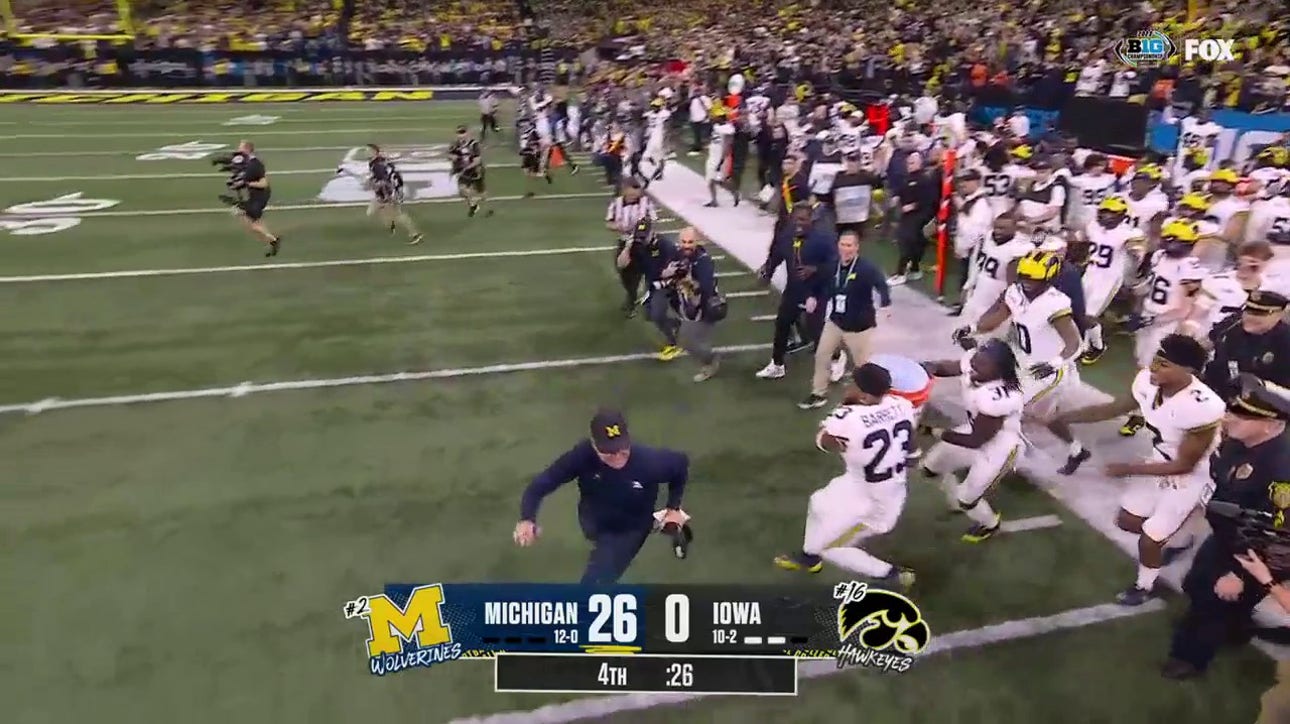 Michigan's Jim Harbaugh evades Gatorade bath after defeating Iowa in Big Ten title game