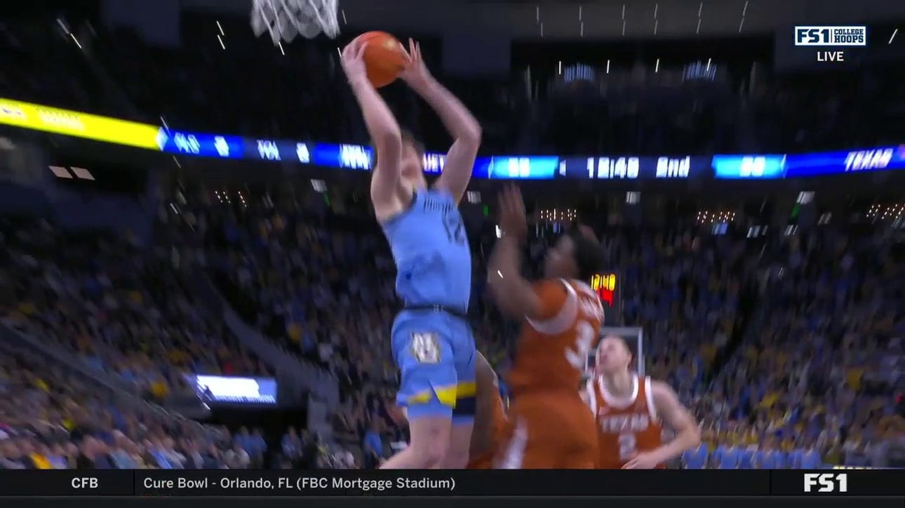 Marquette's Ben Gold storms up the middle and secures the and-1 against Texas
