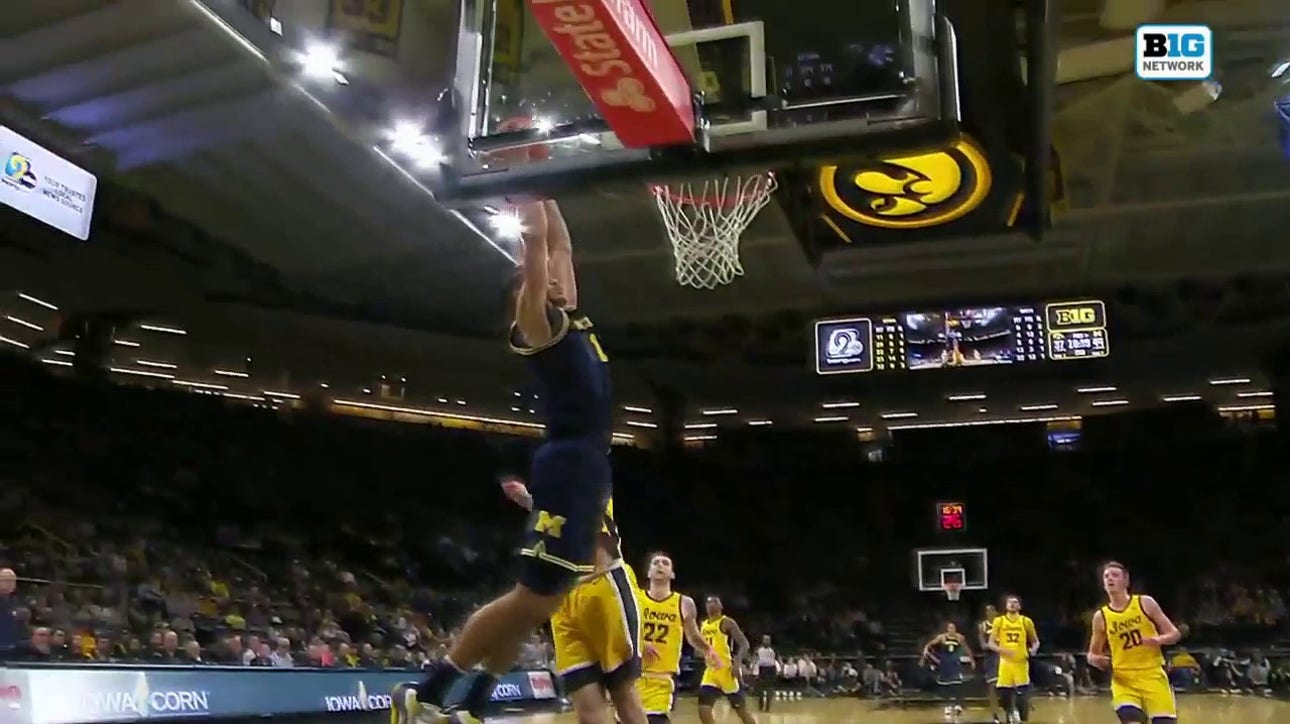 Dug McDaniel finds Olivier Nkamhoua on a strong two-handed alley-oop to extend Michigan's lead over Iowa