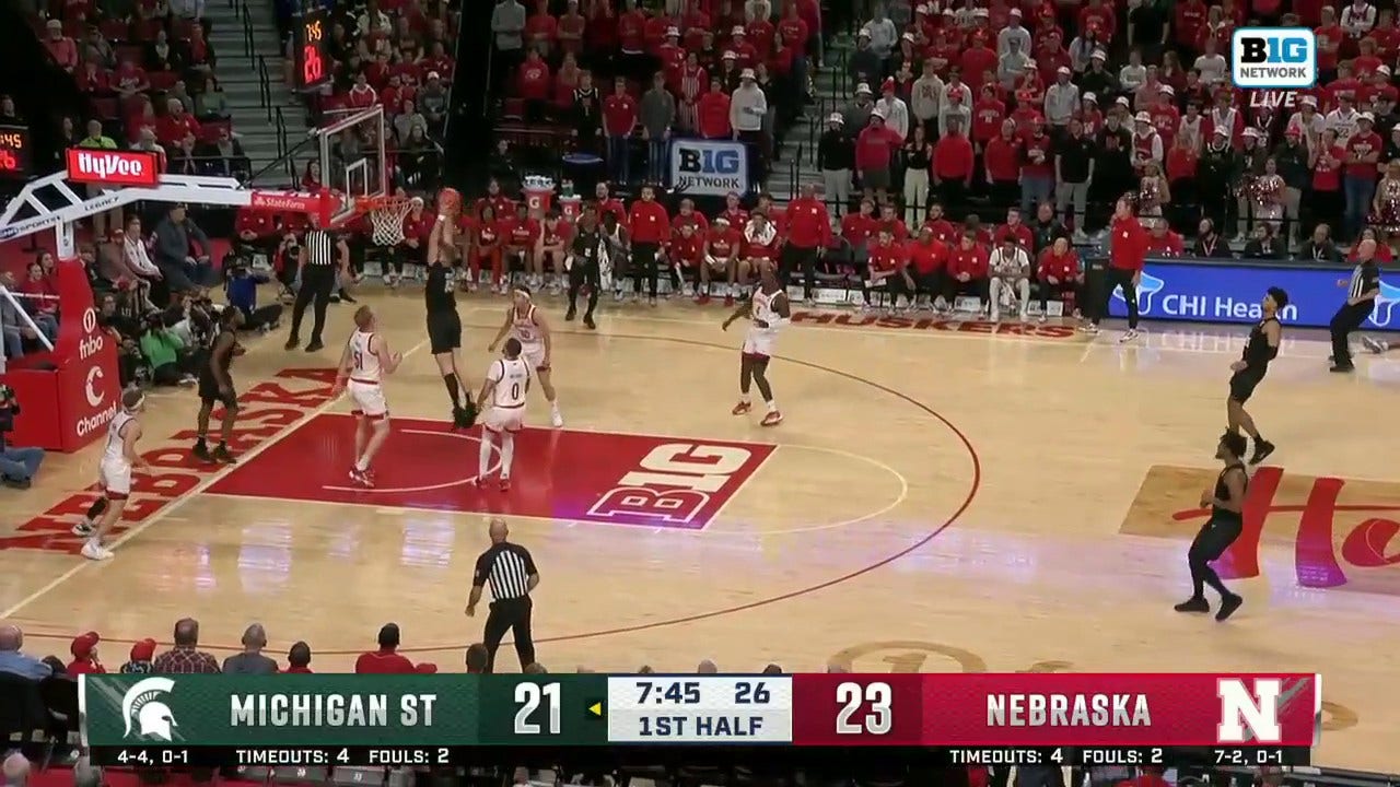 Carson Cooper throws down a strong two-handed dunk to help Michigan State tie the game against Nebraska