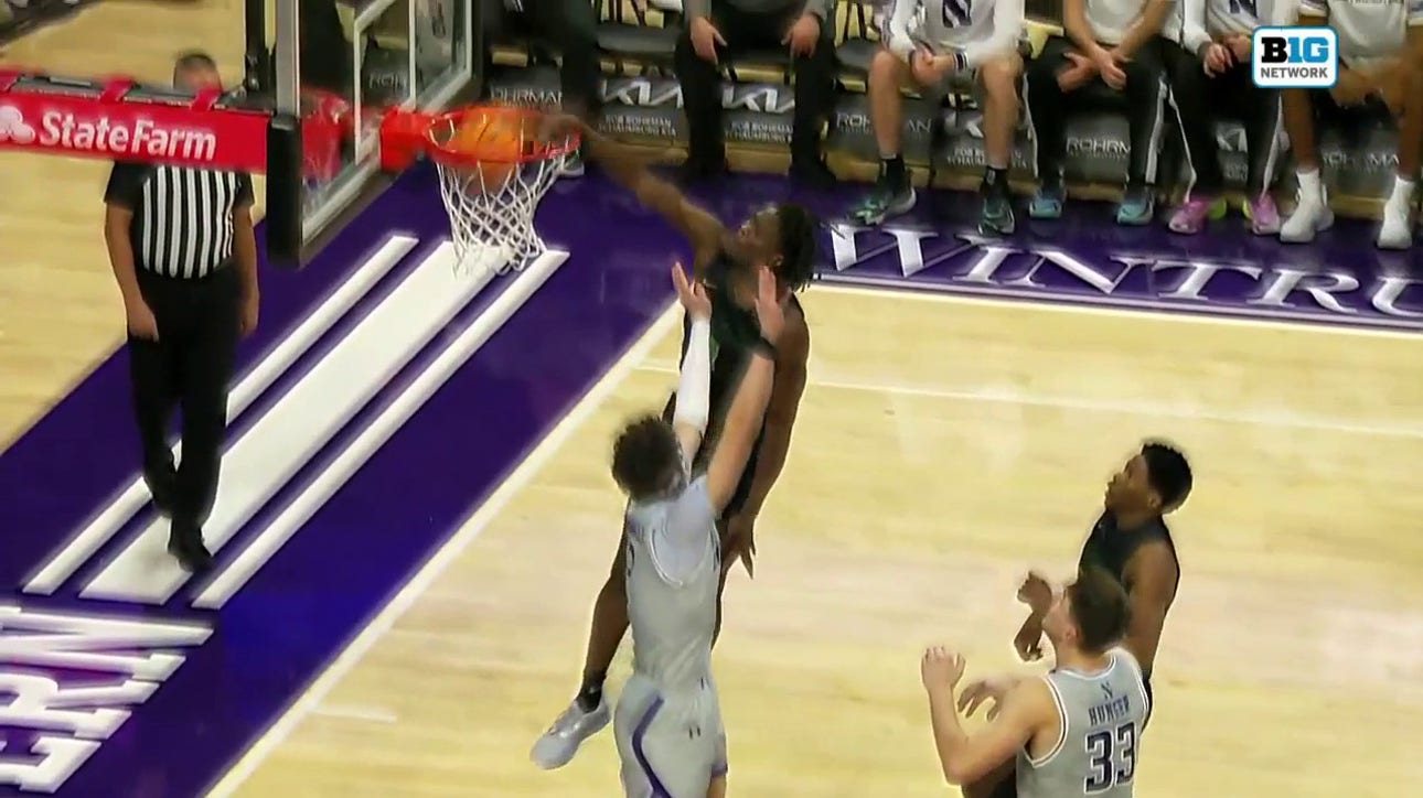 Chicago State's Wesley Cardet Jr. throws down a strong tomahawk slam to shrink Northwestern's lead