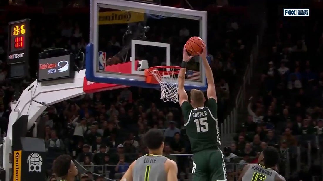 Michigan State's Carson Cooper throws down a vicious alley-oop on the lob from A.J. Hoggard