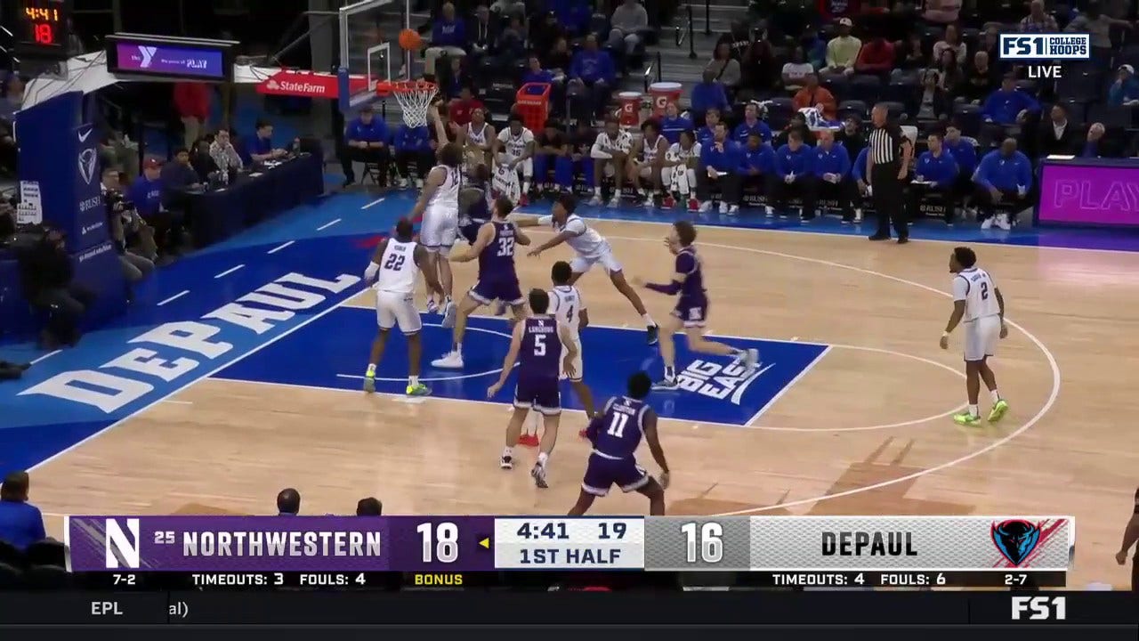 Northwestern's Boo Buie drives baseline for a reverse layup vs. DePaul