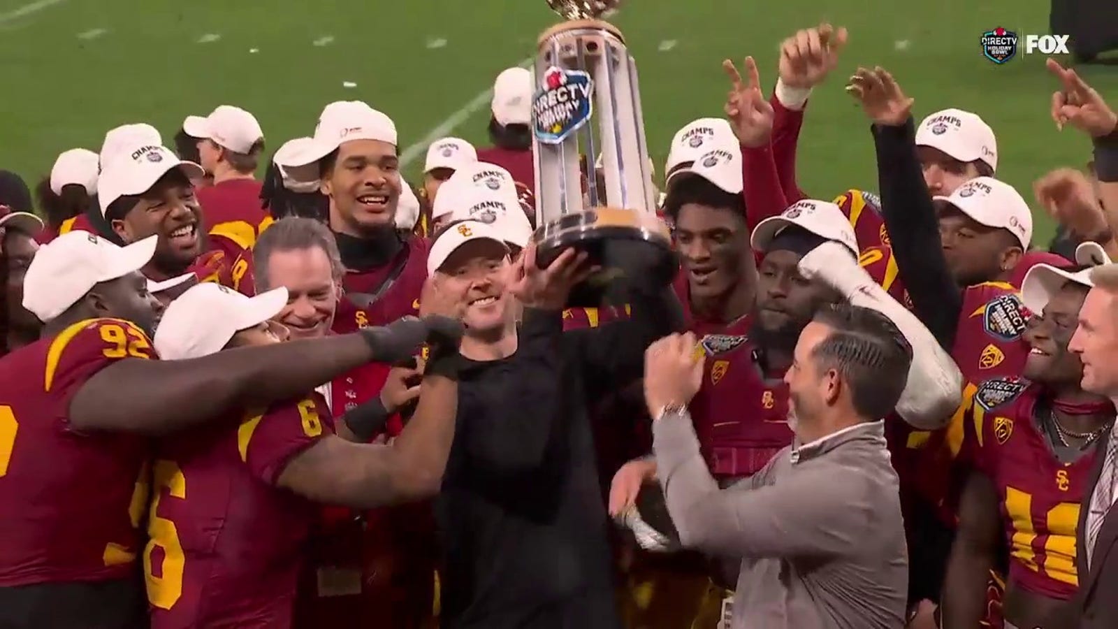 USC hoists the Holiday Bowl trophy