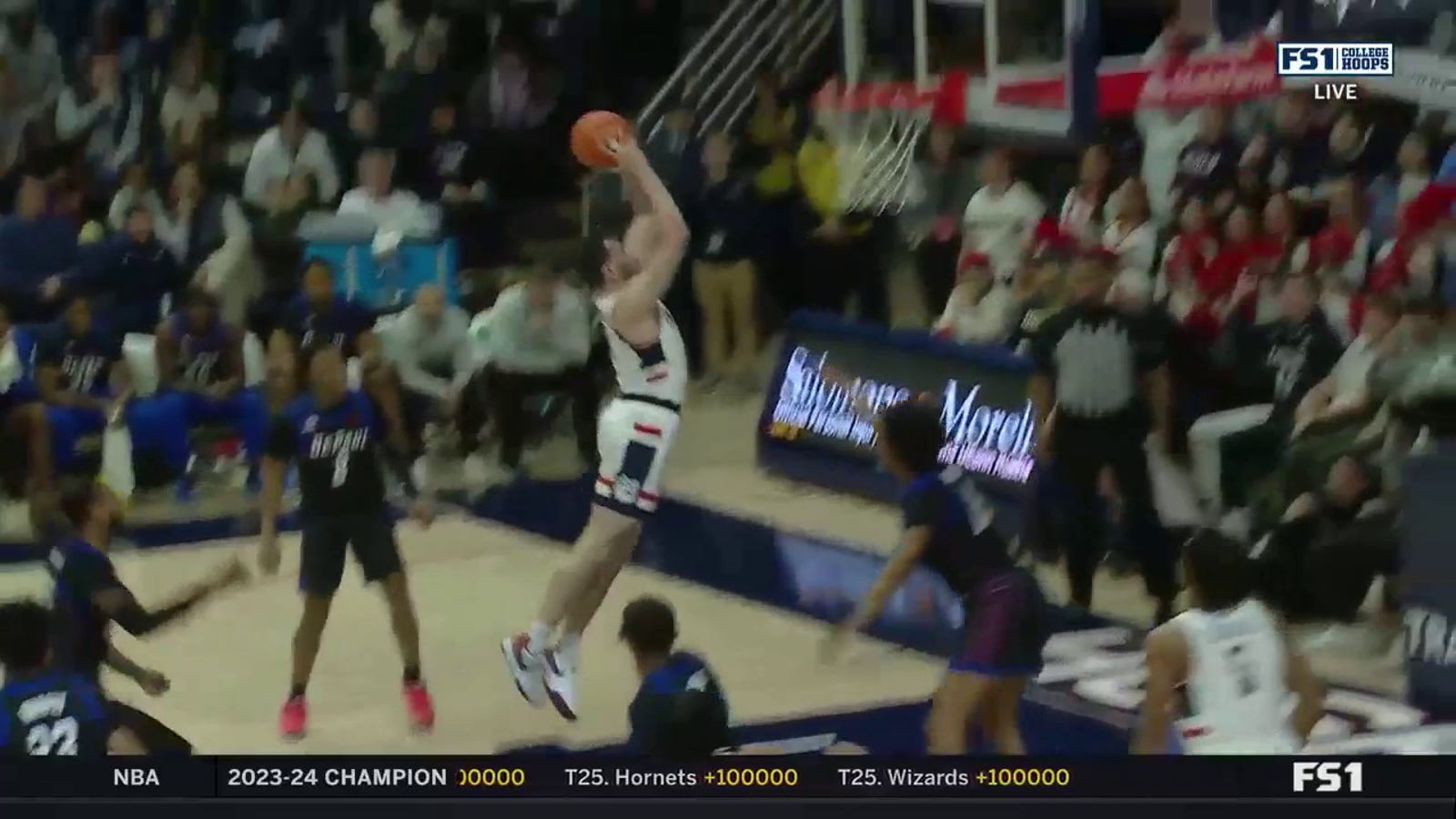 UConn's Alex Karaban goes flying up the middle for a two-handed dunk against DePaul