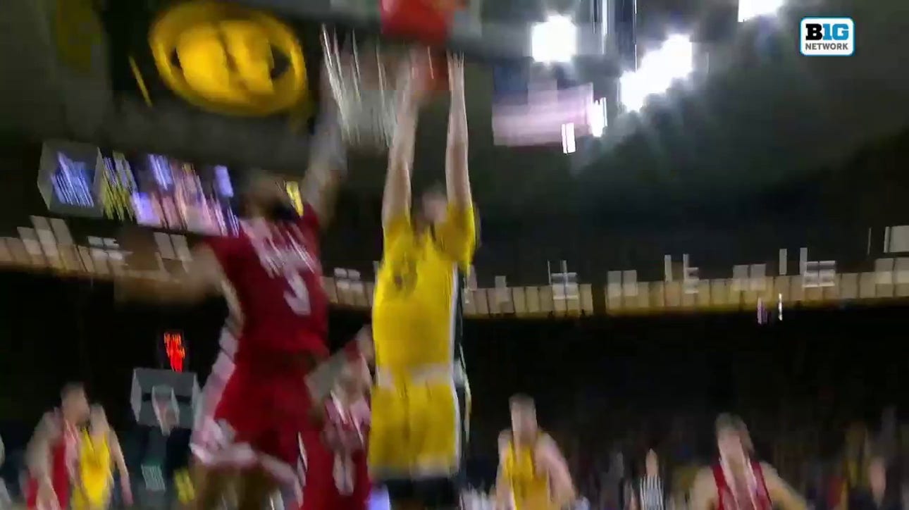 Owen Freeman rises for a strong two-handed slam to extend Iowa's lead over Nebraska