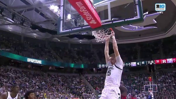 Carson Cooper hammers a two-handed jam to extend Michigan State's lead over Rutgers