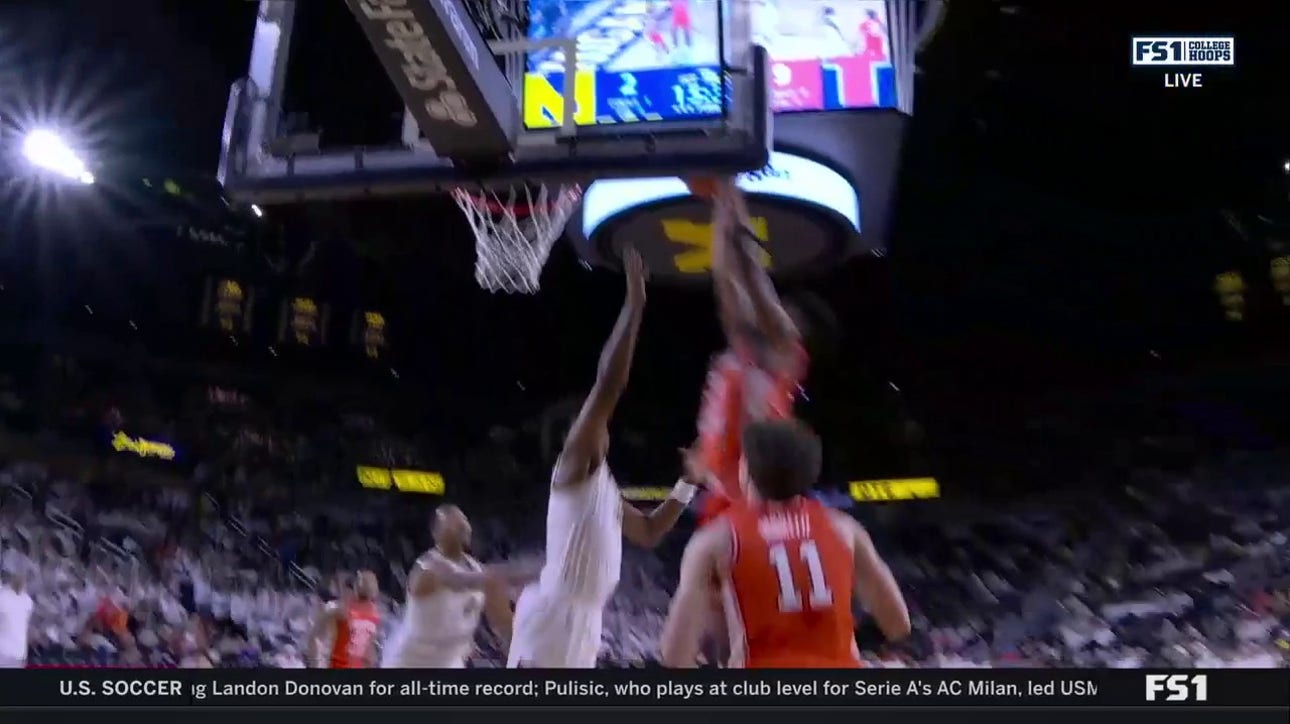 Quincy Guerrier rises for a strong put-back dunk to extend Illinois' lead over Michigan
