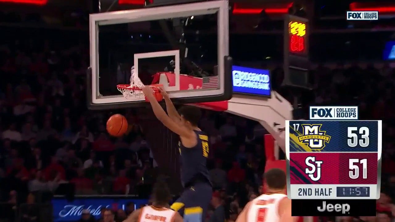 Marquette's Oso Ighodaro delivers the two-handed jam off the lob from Tyler Kolek