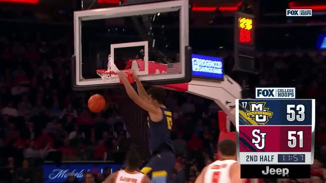 Marquette's Oso Ighodaro delivers the two-handed jam off the lob from Tyler Kolek