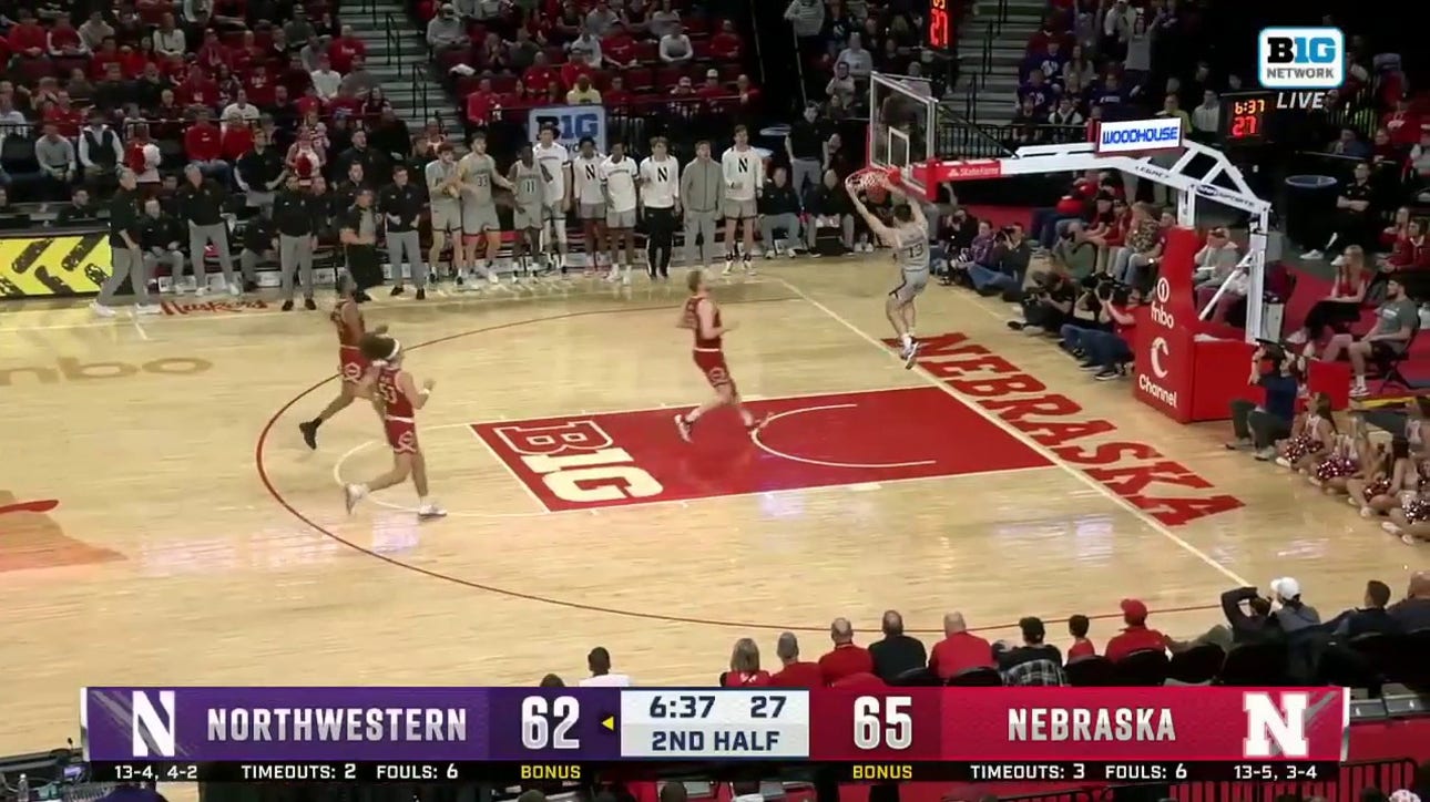 Northwestern's Brooks Barnhizer steals the ball and finishes it with a slam dunk against Nebraska