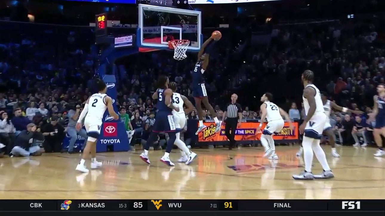 Samson Johnson throws down a strong two-handed alley-oop to extend UConn's lead over Villanova