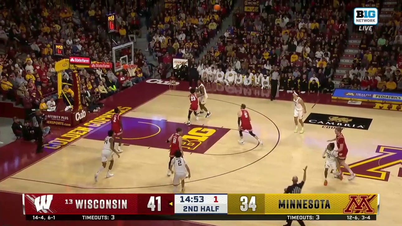 Minnesota's Elijah Hawkins drains a 3-pointer from the logo as the shot clock expires vs. Wisconsin