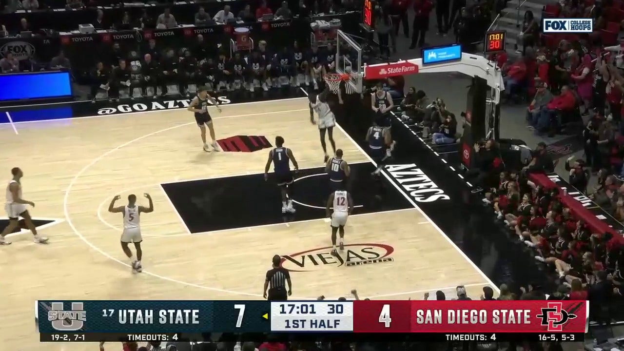 San Diego State's Jay Pal drives inside for the two-handed flush against Utah State