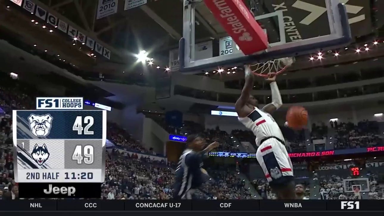 Samson Johnson throws down an alley-oop dunk, extending UConn's lead vs. Butler
