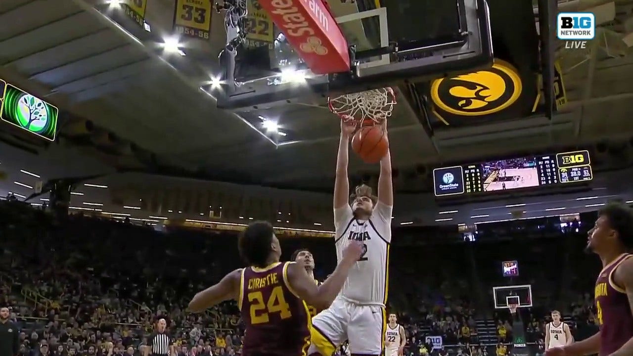 Iowa's Owen Freeman finishes the put-back dunk to close the gap against Minnesota