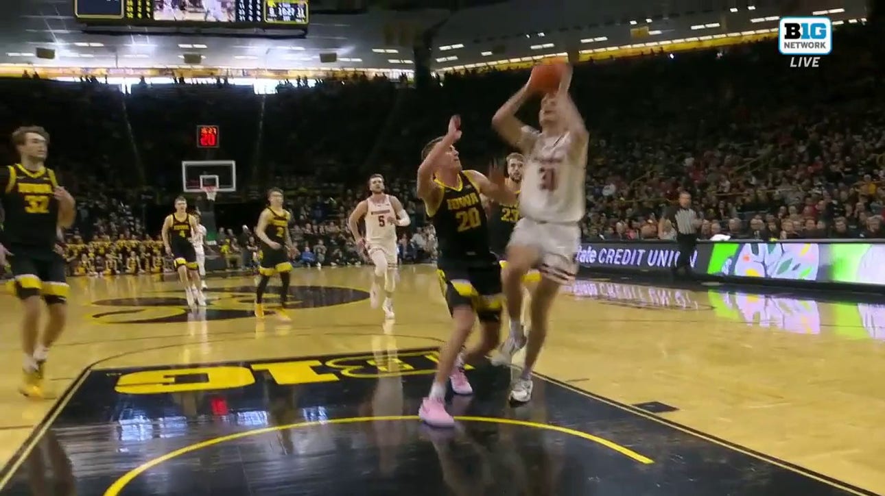 Wisconsin's Nolan Winter finishes a tough and-1 against Iowa