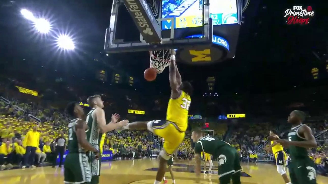 Michigan's Tarris Reed Jr. delivers a powerful two-handed dunk against Michigan State