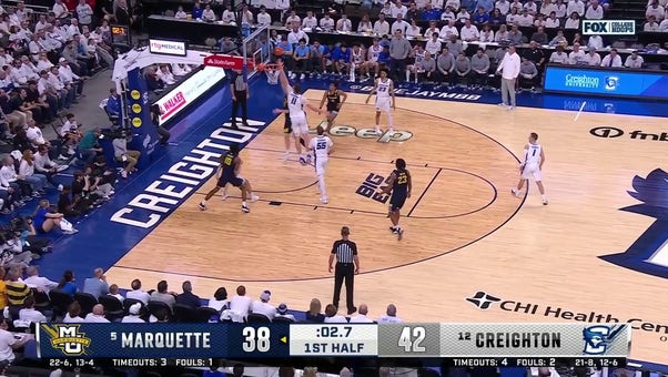 Marquette's Ben Gold finishes a last-second layup to shrink Creighton's lead to 2 at halftime