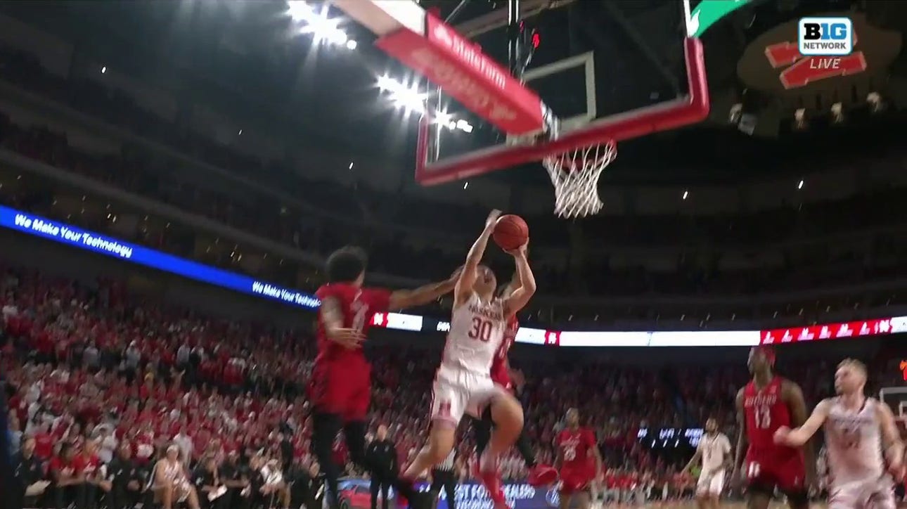 Nebraska's Keisei Tominaga drives to the basket and secures the and-1 finish