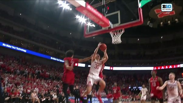 Nebraska's Keisei Tominaga drives to the basket and secures the and-1 finish