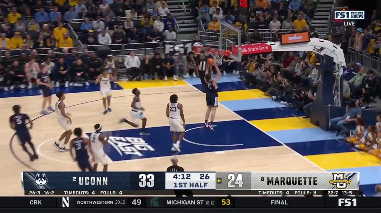 Stephon Castle finds Alex Karaban on the break for a strong two-handed slam to extend UConn's lead over Marquette