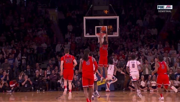 St. John's Zuby Ejiofor throws down a strong two-handed dunk in transition to trim UConn's lead heading into halftime