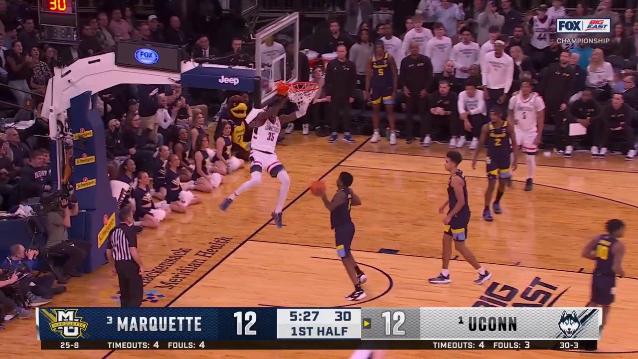 Samson Johnson slams home the dunk in transition to give UConn the lead against Marquette