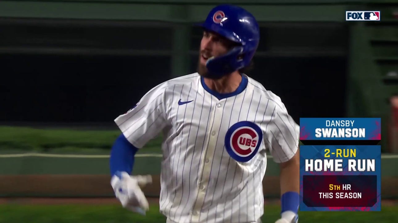 Dansby Swanson crushes a two-run home run to give the Cubs a 7-5 lead over the Reds