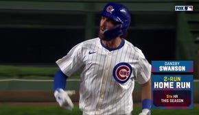 Dansby Swanson crushes a two-run home run to give the Cubs a 7-5 lead over the Reds