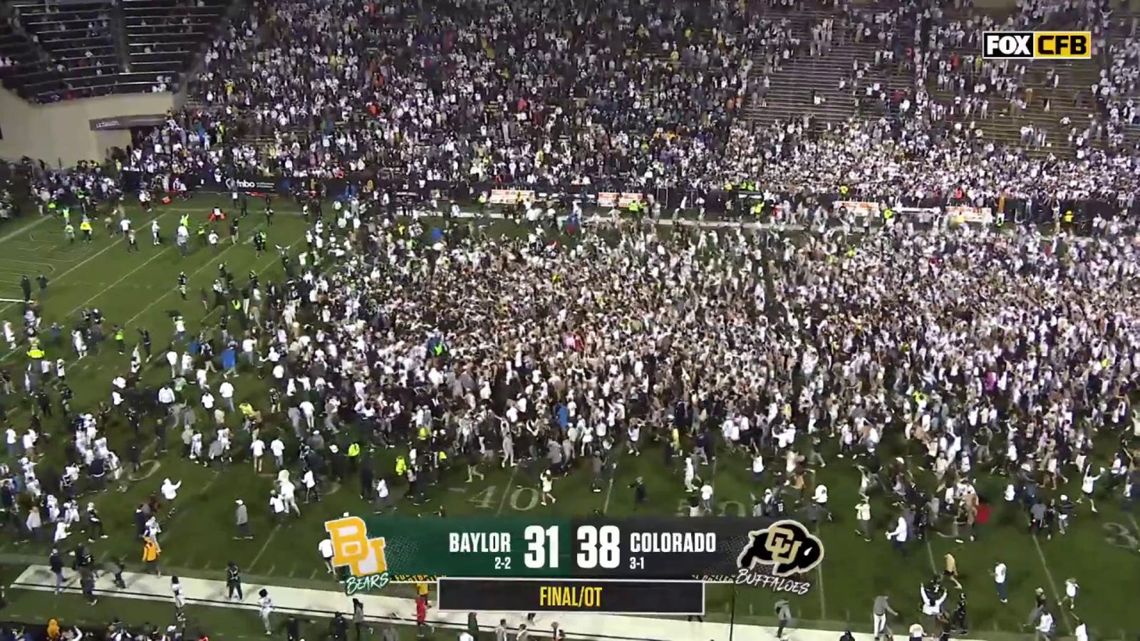 Fans storm the field after Colorado's Travis Hunter forces a Baylor fumble through the end zone and seals a 38-31 win in OT