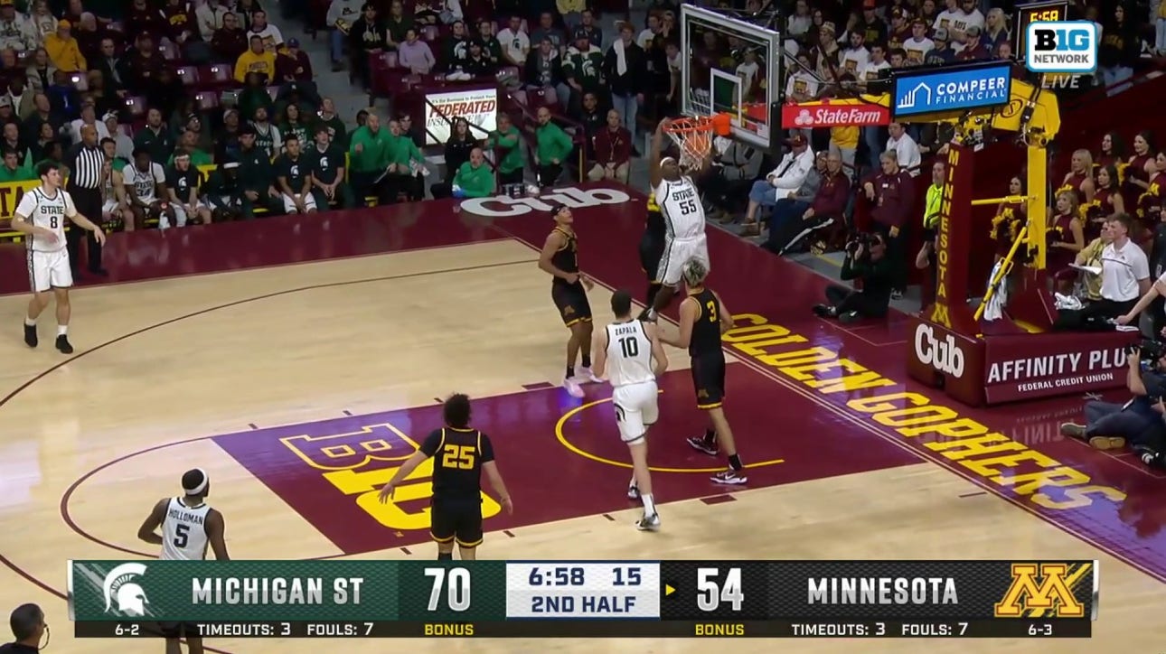 Coen Carr throws down a powerful two-handed slam, extending Michigan State's lead over Minnesota