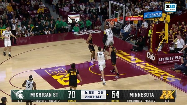 Coen Carr throws down a powerful two-handed slam, extending Michigan State's lead over Minnesota