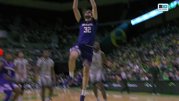 Wilhelm Breidenbach throws down a two-handed slam dunk, extending Washington's lead over Oregon