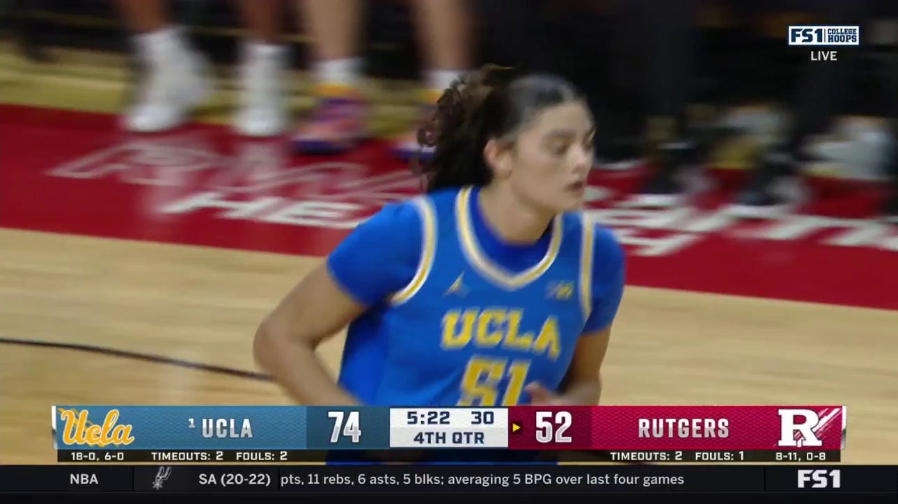 Lauren Betts muscles her way inside for the tough bucket, extending UCLA's lead over Rutgers