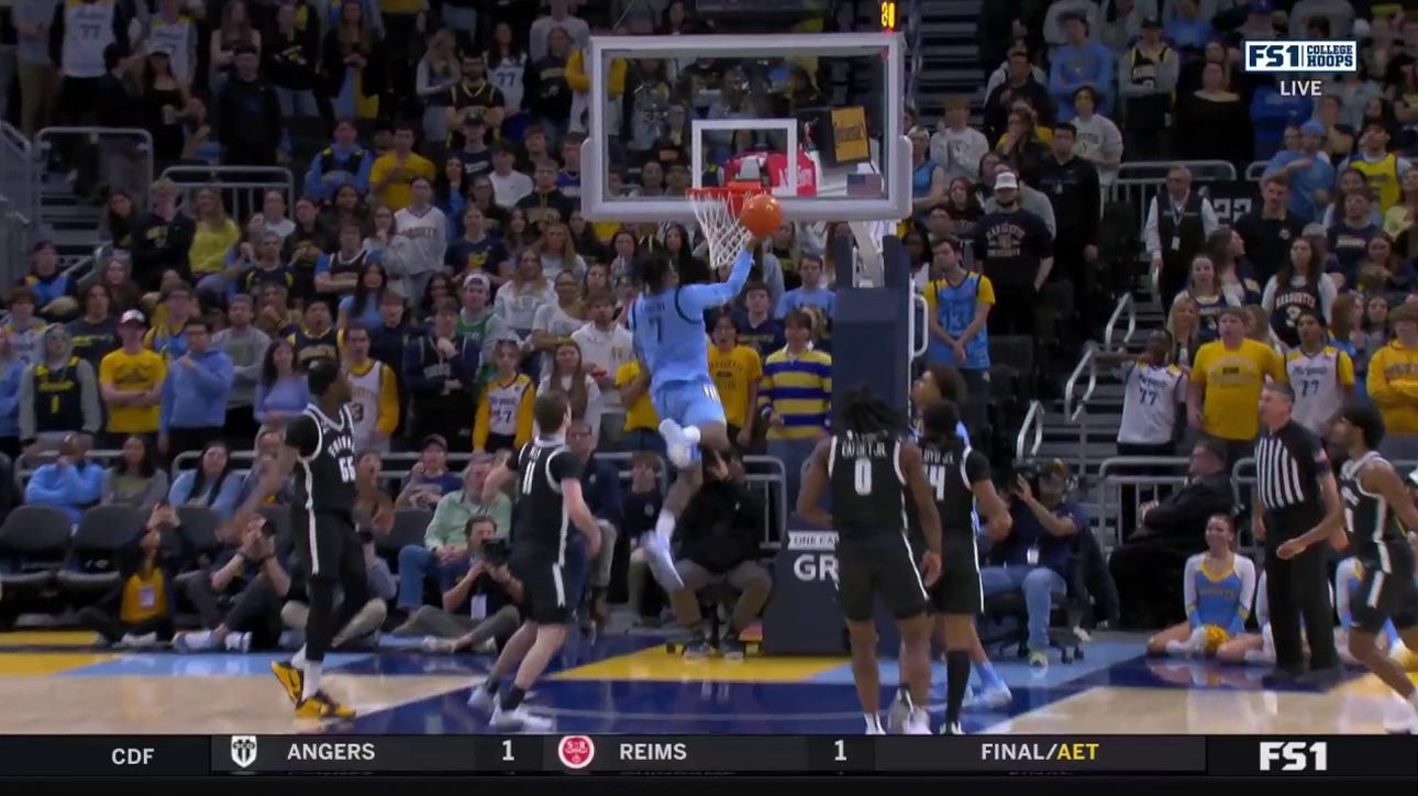 Zaide Lowery makes an acrobatic layup, extending Marquette's lead over Providence 