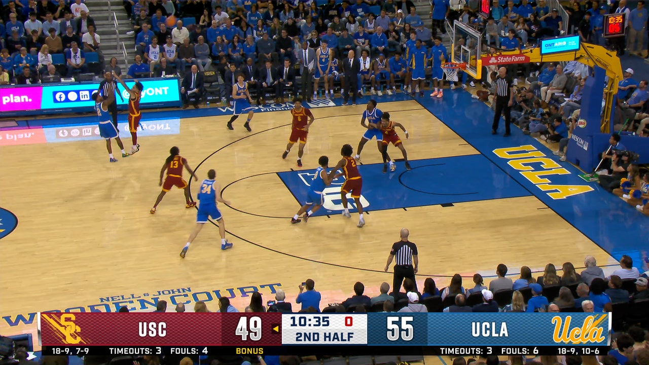 UCLA's Donovan Dent knocks down a three, beating the shot clock against the USC Trojans